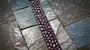 Cast iron trench grate in river rock pattern