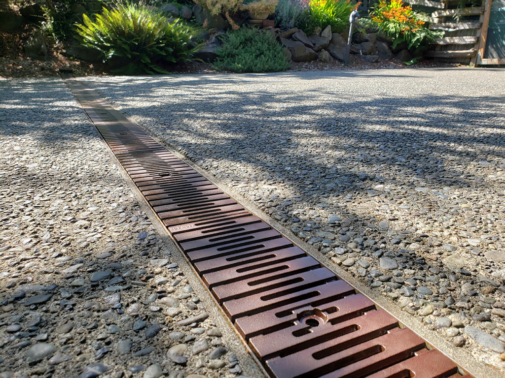 Cast iron drain grate with baked-on-oil finish in Kurf pattern
