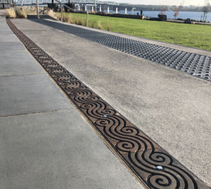 Cast iron trench grate in decorative Argo pattern by Iron Age Designs. Waterfront Park installation.