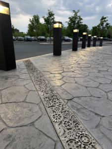 Raw Cast Aluminum solid trench grates in decorative Dynamo pattern that looks like interlocking gears from Iron Age Designs.