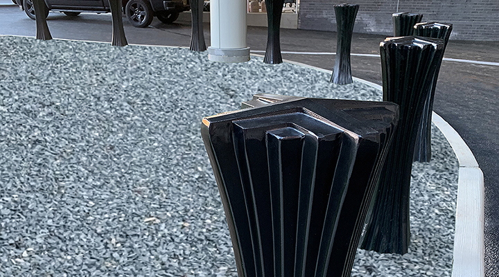 Decorative cast aluminum bollard with powder coat finish and unique geometric relief