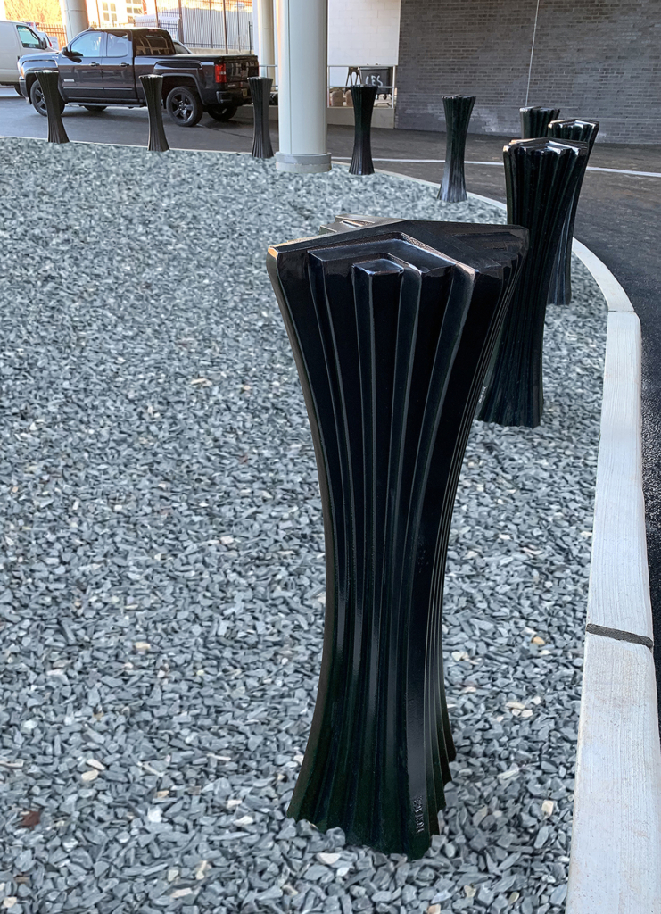 Decorative cast aluminum bollard with powder coat finish and unique geometric relief