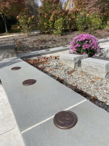 Raw cast iron medallions as memorial grid markers