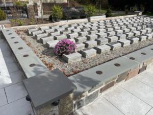 Raw cast iron medallions as memorial grid markers