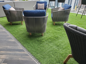 Decorative cast aluminum trench grate in classic Interlaken pattern on rooftop pool deck and restaurant