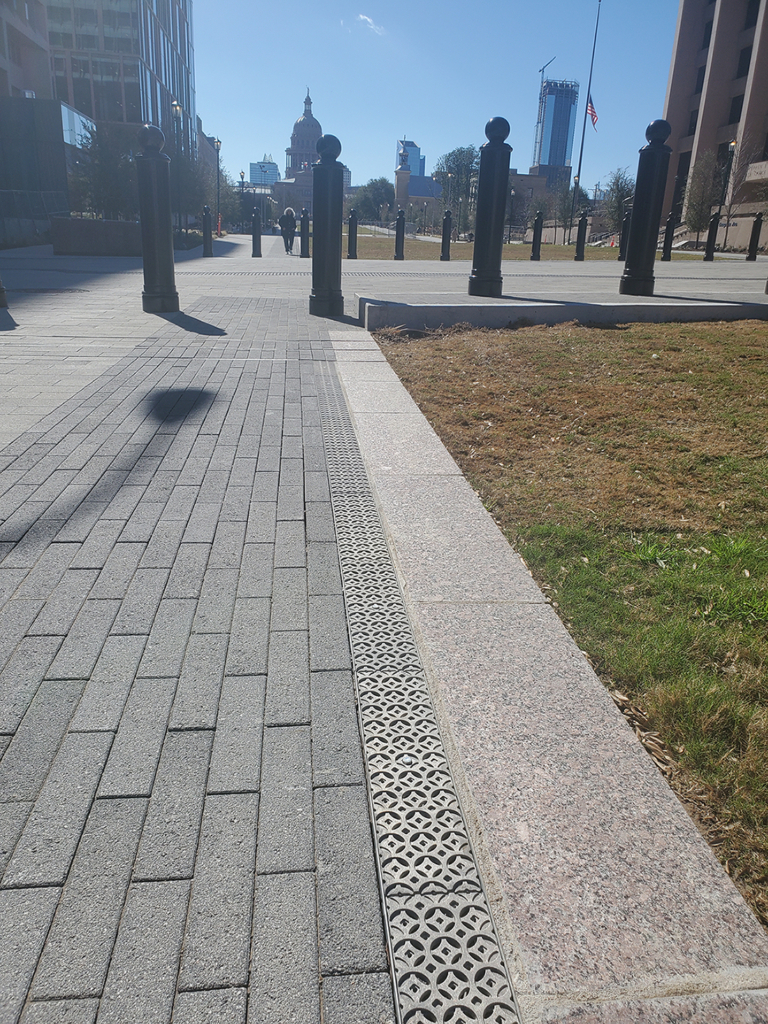 Cast aluminum trench drain grates in decorative Interlaken pattern