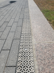 Cast aluminum trench drain grates in decorative Interlaken pattern
