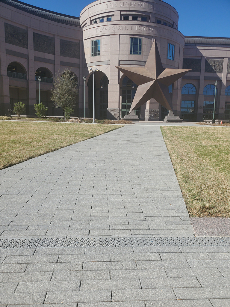 Cast aluminum trench drain grates in decorative Interlaken pattern