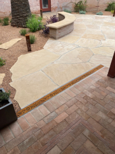 Decorative cast iron trench grate installed in paver patio