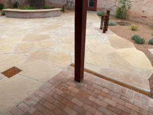 Decorative cast iron trench grate installed in paver patio