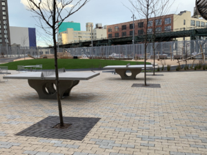 Decorative cast iron tree grates in Rain pattern installed in paver courtyard park