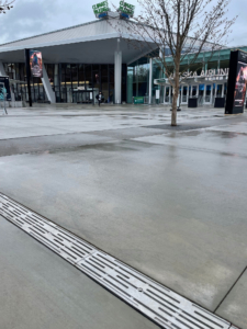 Cast aluminum decorative trench grate installed in entry plaza to Climate Pledge Arena