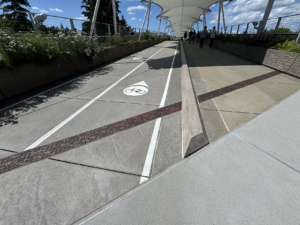 Raw cast iron trench grate in decorative Rain pattern from Iron Age Designs. Transit center installation.