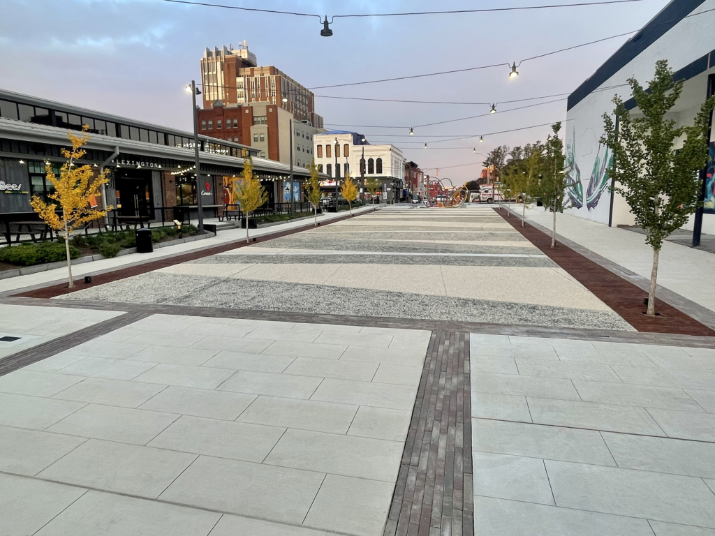 Large cast iron tree grate array in decorative Rain pattern, installed in front of Lexington Market