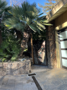 Decorative cast iron trench grates in River Rock pattern, installed in residential driveway