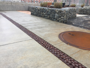 Cast iron trench drain grates in realistic River Rock pattern