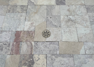 Decorative cast bronze shower drain grate featuring Anise star pattern.