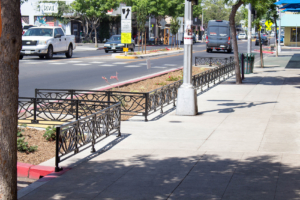 Decorative cast iron planter fence in Belle pattern with black powder coat finish.