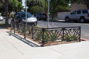 Decorative cast iron planter fence in Belle pattern with black powder coat finish.