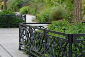 Decorative cast iron planter fence in Belle pattern with black powder coat finish.