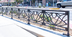 Decorative cast iron planter fence in Belle pattern with black powder coat finish.