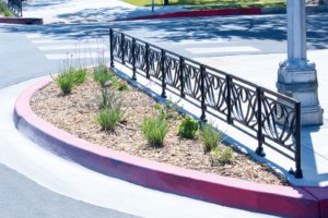 Decorative cast iron planter fence in Belle pattern with black powder coat finish.