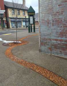 Decorative cast iron radius trench grates with Locust pattern