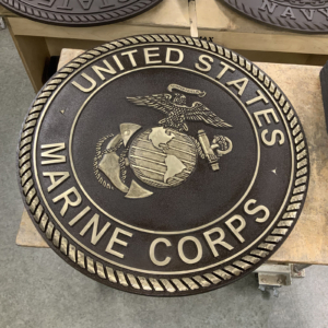 Cast Bronze plaque with "United States Marine Corps" around border and insignia in the middle