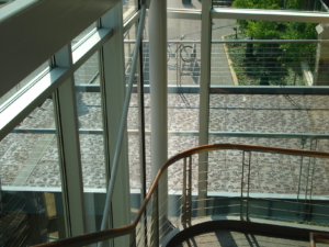 Pedestrian bridge arrayed with cast iron grate panels in a decorative Locust leaf pattern