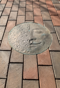 Cast bronze Moon Face embed plaque showing Half Moon face