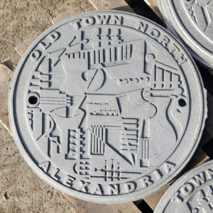 Raw cast iron plaque for Old Town North, Alexandria, VA with a music motif celebrating the city's culture