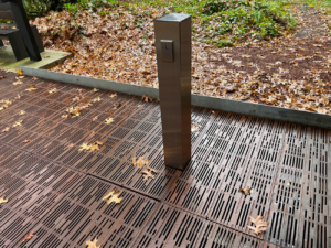 Decorative cast metal pedestrian bridge with ADA door button post