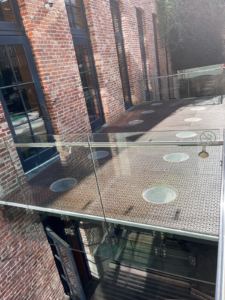 Pedestrian bridge made from decorative cast iron panels with light holes.