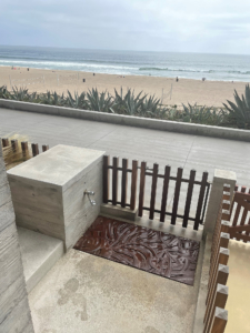 Decorative cast iron grate with Kelp pattern installed as floor of beach foot bath.