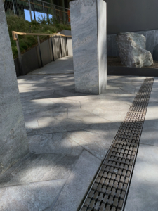 Decorative cast iron trench grate in Plex pattern installed in pavers