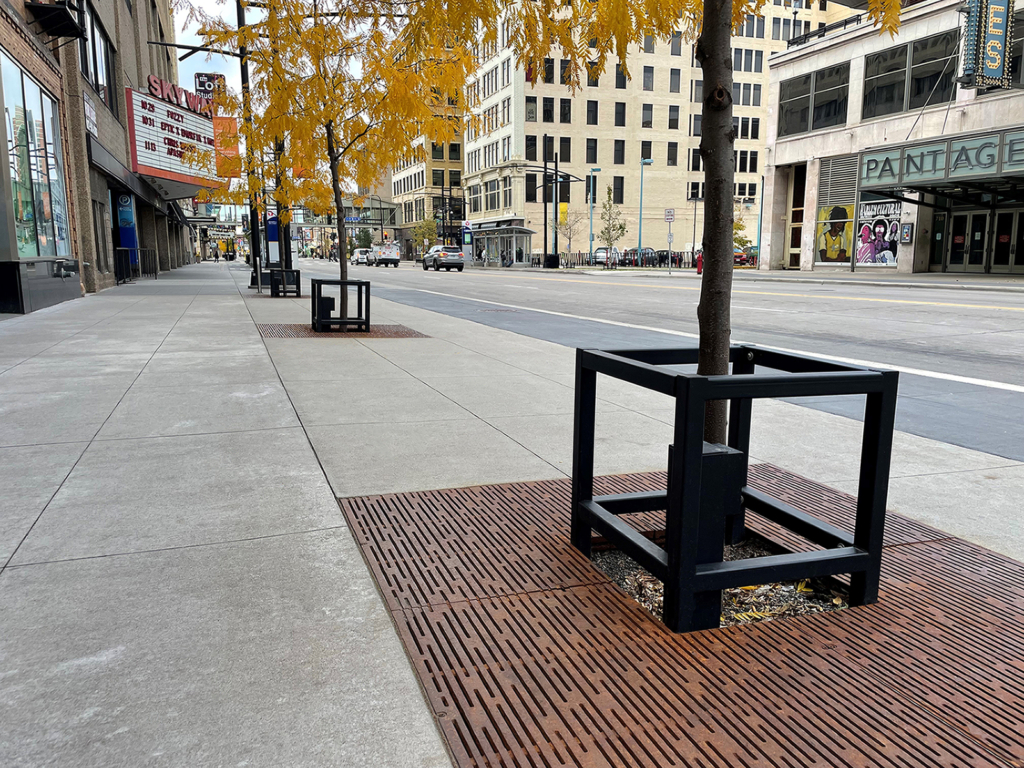Custom square tree guard and cast iron tree grate in Rain pattern, both from Iron Age Designs.