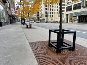 Custom square tree guard and cast iron tree grate in Rain pattern, both from Iron Age Designs.