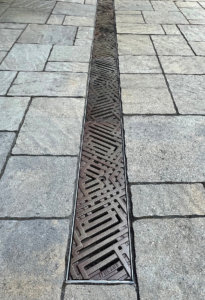 Decorative cast iron trench grates with southwest influenced Thunderbird pattern
