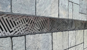 Decorative cast iron trench grates with southwest influenced Thunderbird pattern