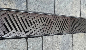 Decorative cast iron trench grates with southwest influenced Thunderbird pattern