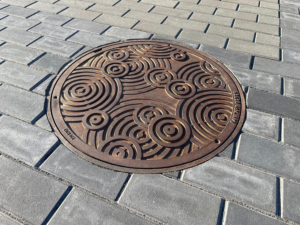 Decorative cast iron manhole cover in Oblio pattern