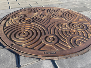 Decorative cast iron manhole cover in Oblio pattern