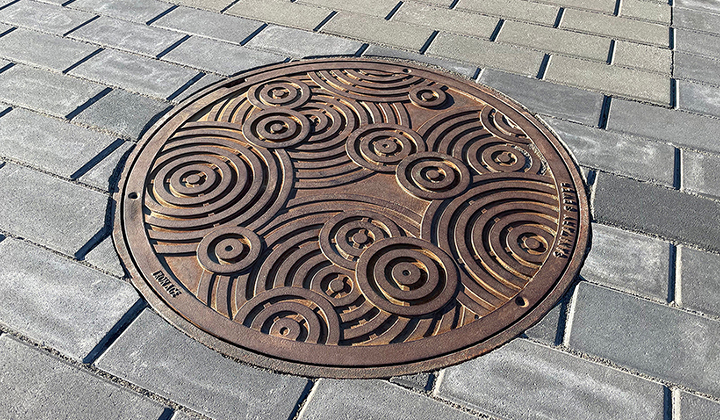 Decorative cast iron manhole cover in Oblio pattern