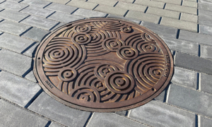 Decorative cast iron manhole cover in Oblio pattern