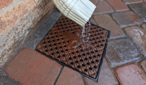Cast iron drain grate with decorative fleur-de-lis pattern