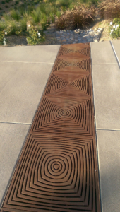 Cast iron grate in decorative Divisadero pattern by Iron Age Designs. Arrayed as bioswale inlet grates.