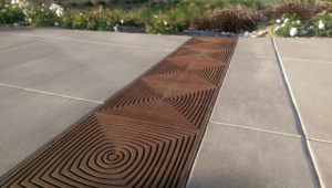 Cast iron grate in decorative Divisadero pattern by Iron Age Designs. Arrayed as bioswale inlet grates.