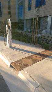Cast iron grate in decorative Divisadero pattern by Iron Age Designs. Arrayed as bioswale inlet grates.