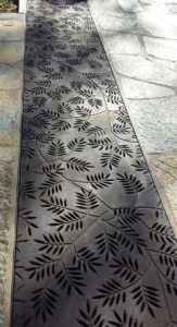 Cast iron grates in decorative Locust pattern by Iron Age Designs. Arrayed as a pedestrian bridge.
