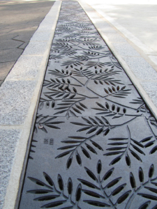 Cast iron grates in decorative Locust pattern by Iron Age Designs. Arrayed as a pedestrian bridge.